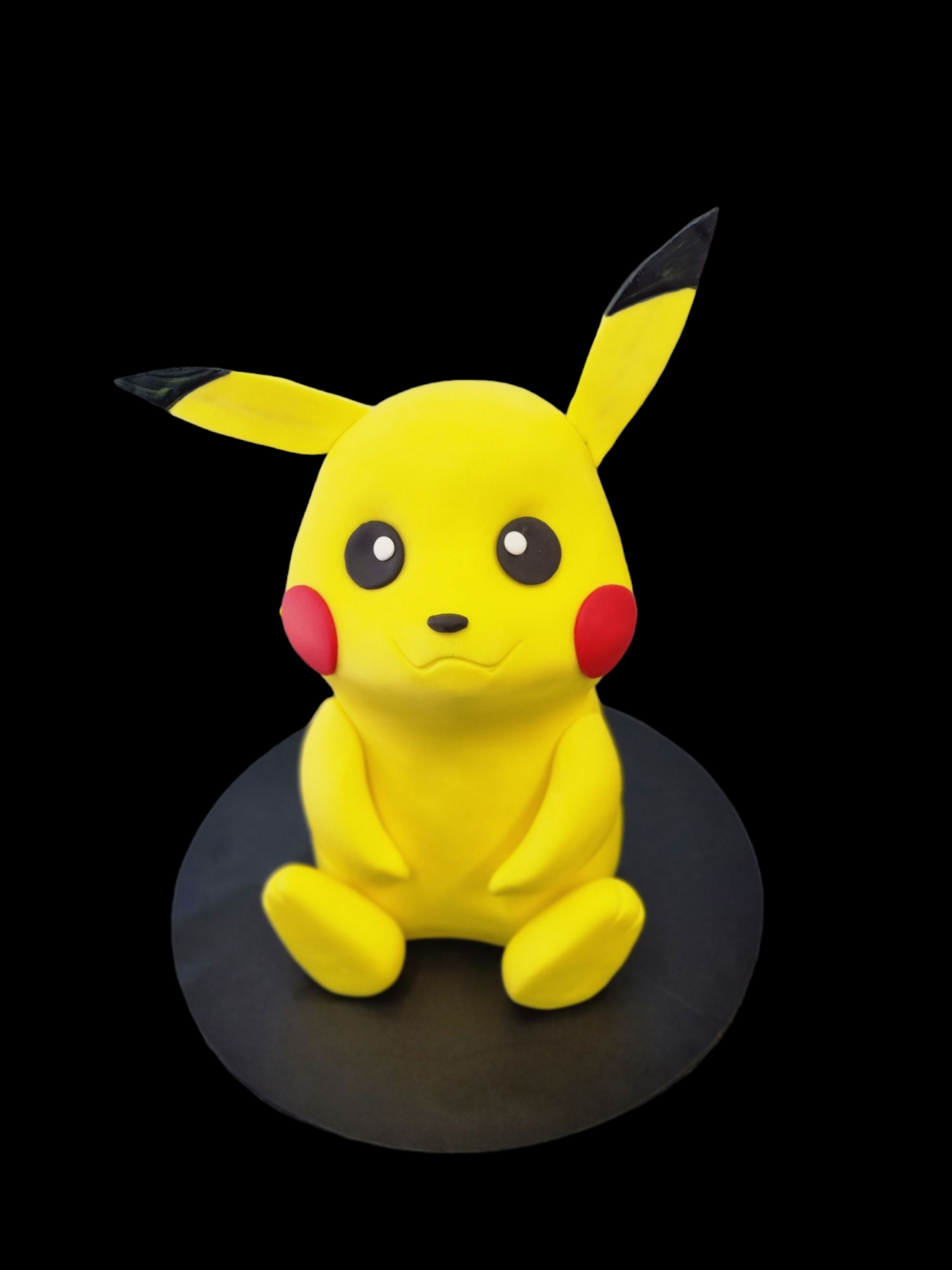 "Adorable Pikachu sculpted cake inspired by the Pokémon series, featuring vibrant yellow fondant, black-tipped ears, and signature red cheeks, displayed on a black base.